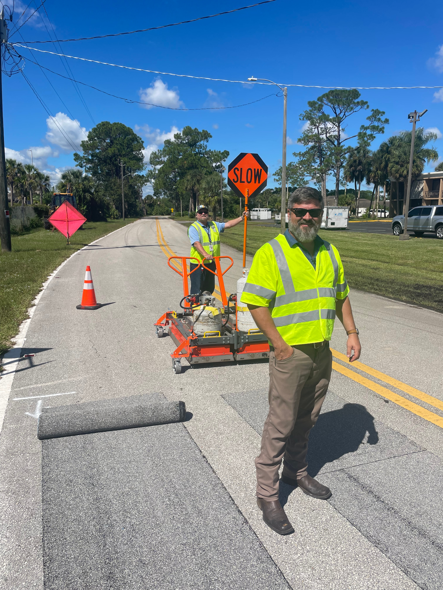 Crew installing Roadway Safety Strip high-friction pavement treatment on an asphalt roadway