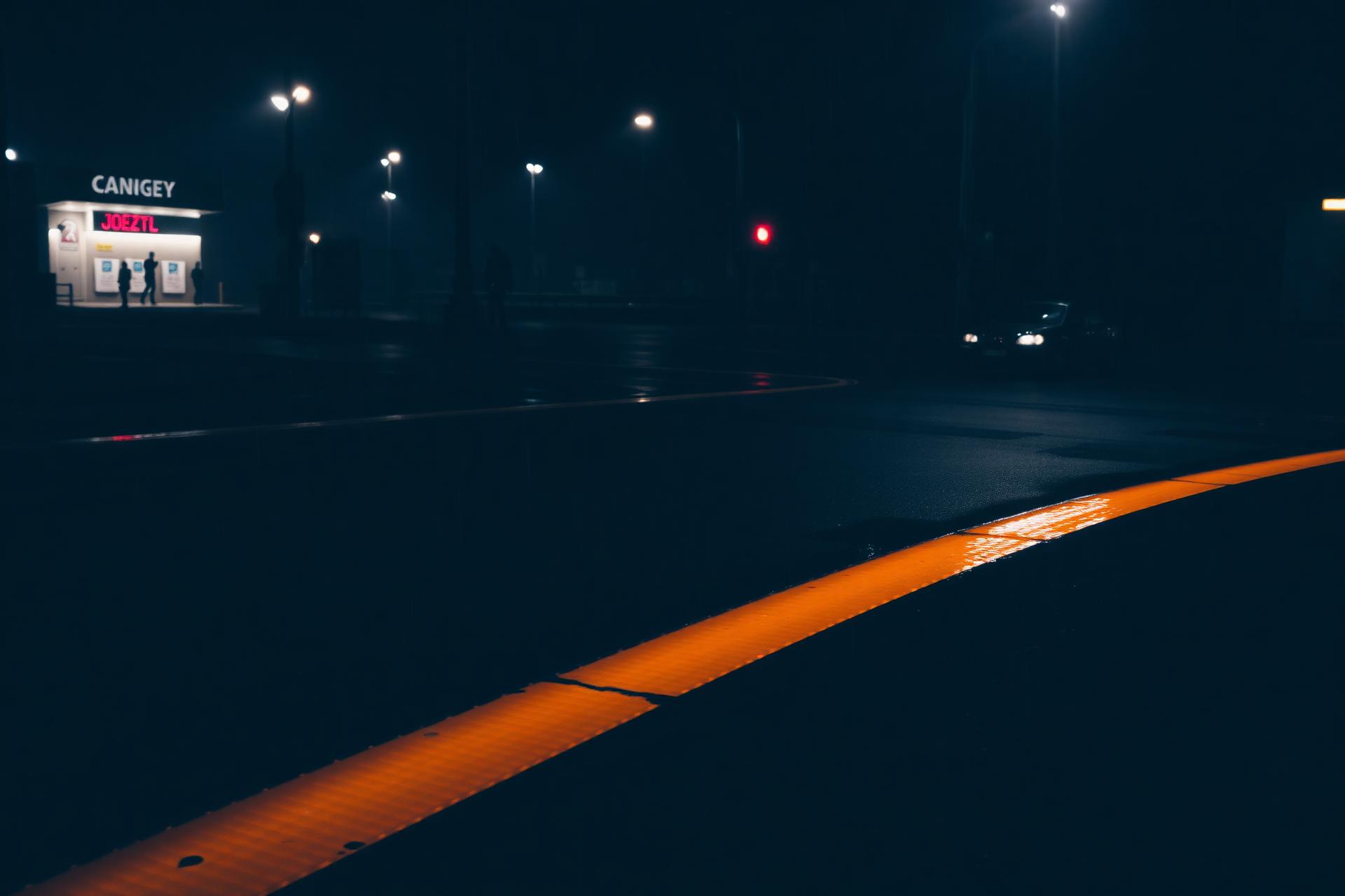 High-friction Roadway Safety Strip pavement treatment applied across a wet crosswalk at night